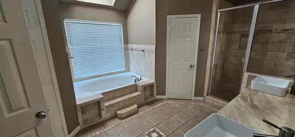 a bathroom with a tub and shower