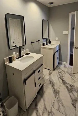 a bathroom with a sink toilet and mirror