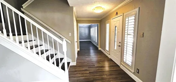 a view of an entryway with wooden floor