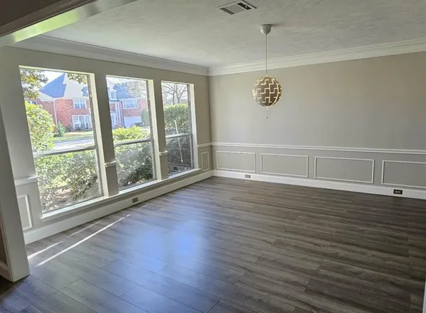a view of room with window and wooden floor