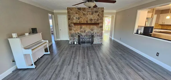 a living room with furniture and a wooden floor