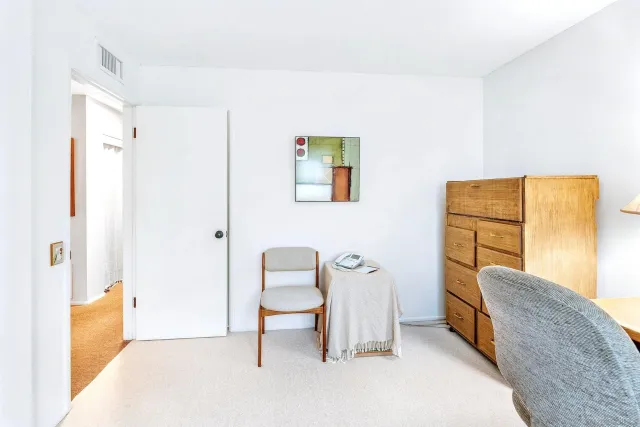 a view of an empty room and a bathroom