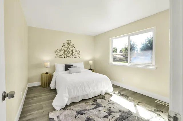 a bedroom with a bed and a window