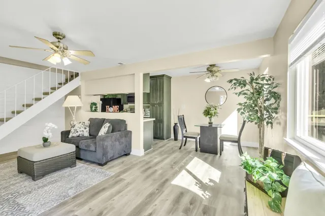 a living room with furniture and a chandelier