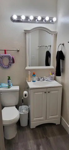 a bathroom with a toilet sink and mirror