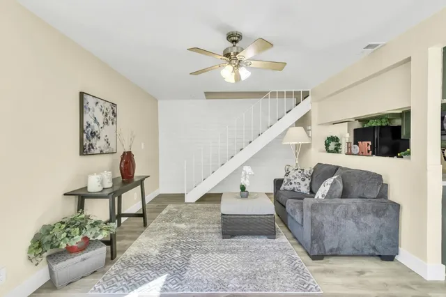 a living room with couches and a coffee table with wooden floor