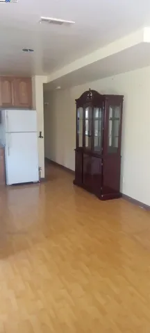 a view of an empty room with a cabinet