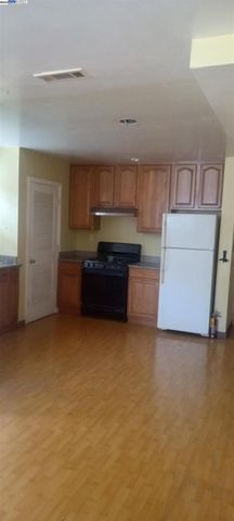 a kitchen with cabinets and a refrigerator