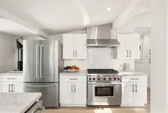 a view of a roof deck with table and chairs with wooden floor and fence