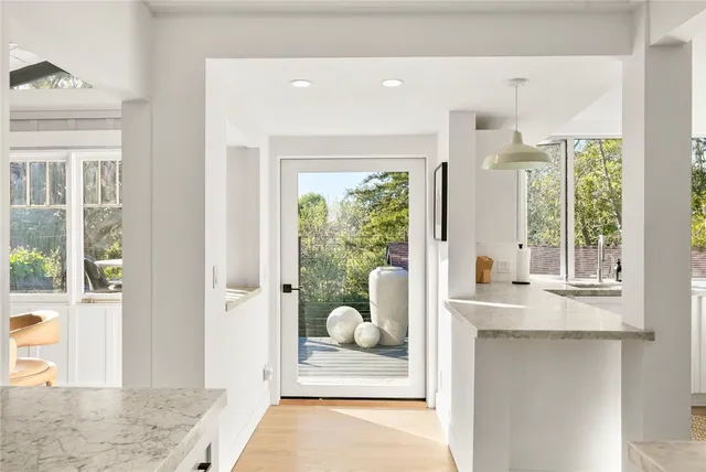 a view of a patio with table and chairs and potted plants