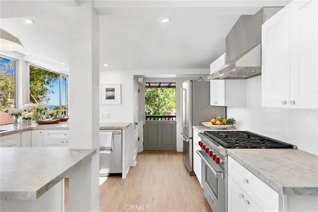 a kitchen with cabinets and wooden floor
