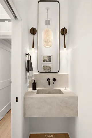 a bathroom with a double vanity sink window and mirror