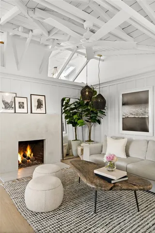 a living room with furniture a chandelier and a rug