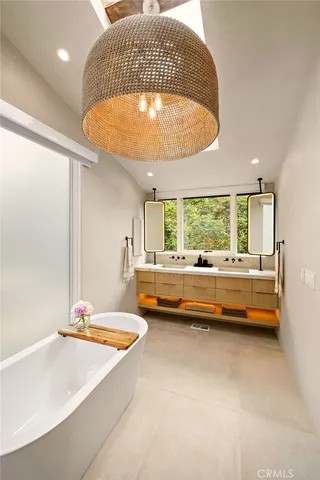 a bathroom with a granite countertop toilet a sink and a window