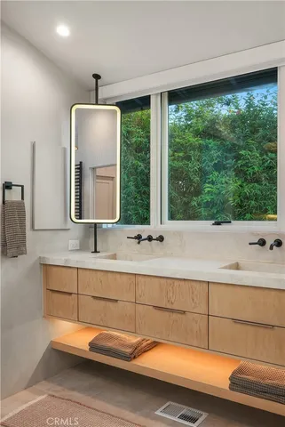 a backyard of a house with table and chairs under an umbrella