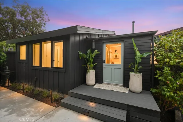 a view of a backyard with a bench and a tree
