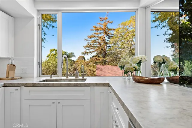 a bathroom with a granite countertop sink a mirror and shower