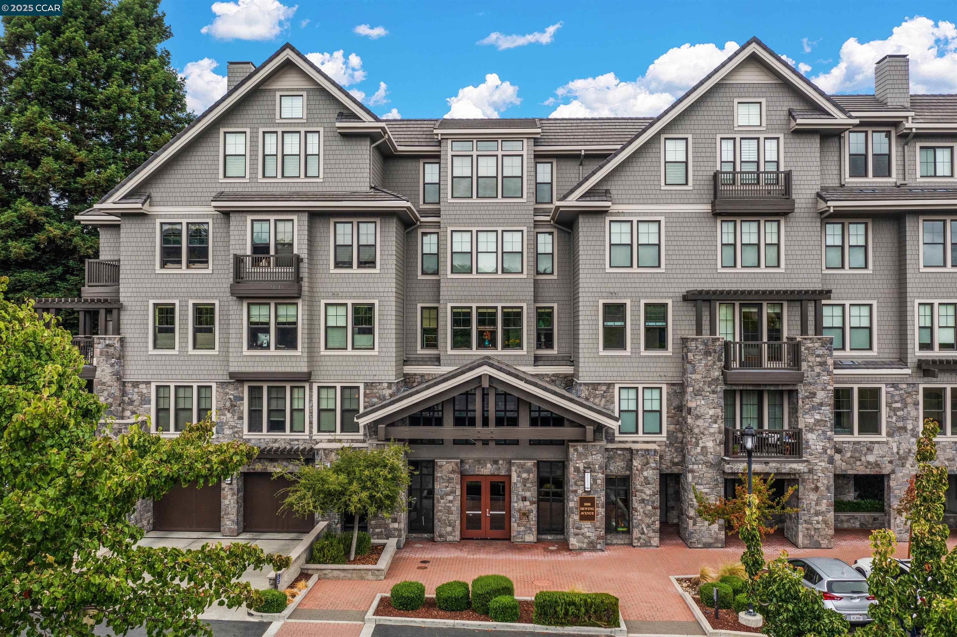 a front view of a residential apartment building with a yard