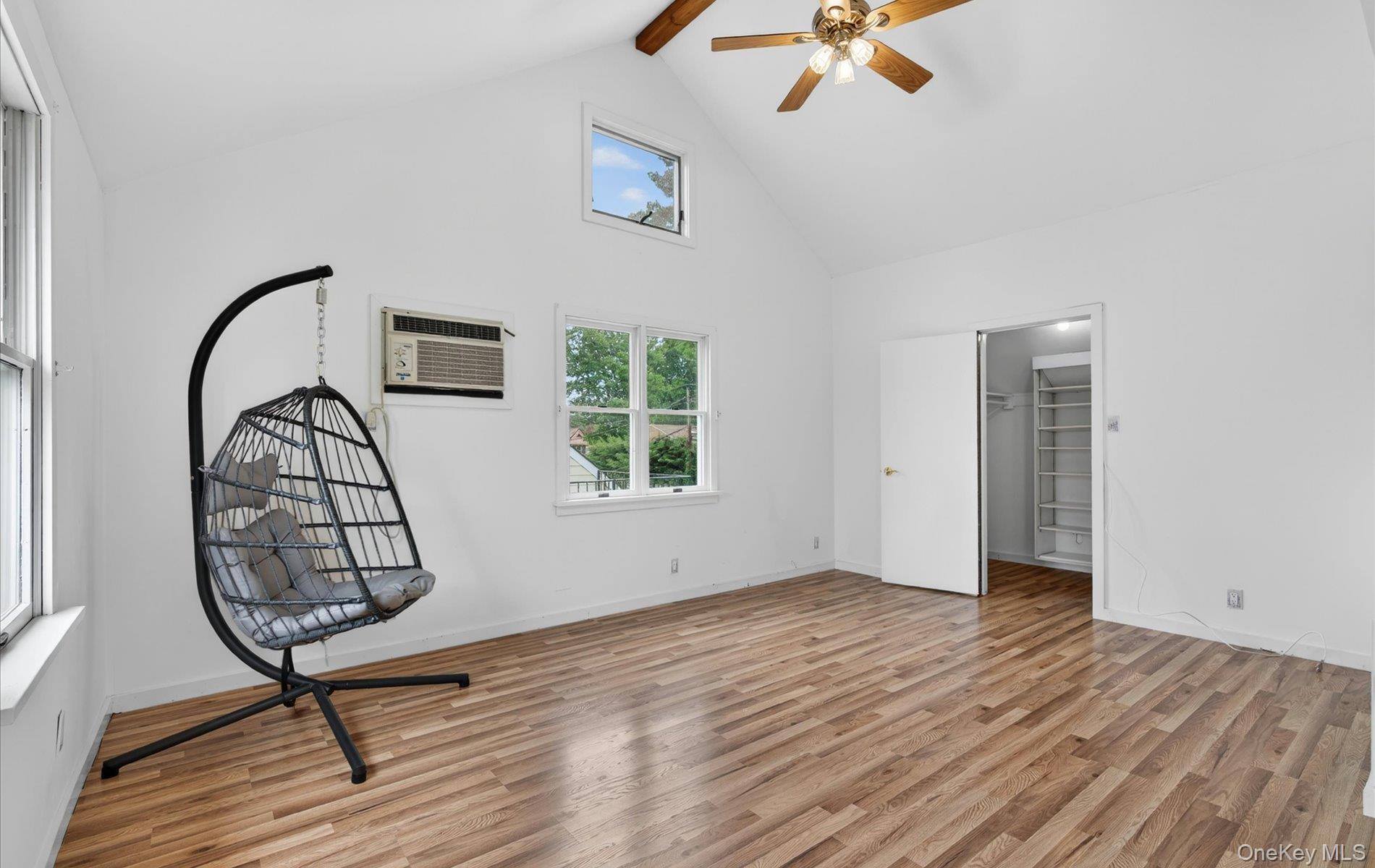 24 Purdue Road Glen Cove, NY 11542 - Photo 25 of 41 a view of a livingroom with wooden floor a chandelier fan and windows