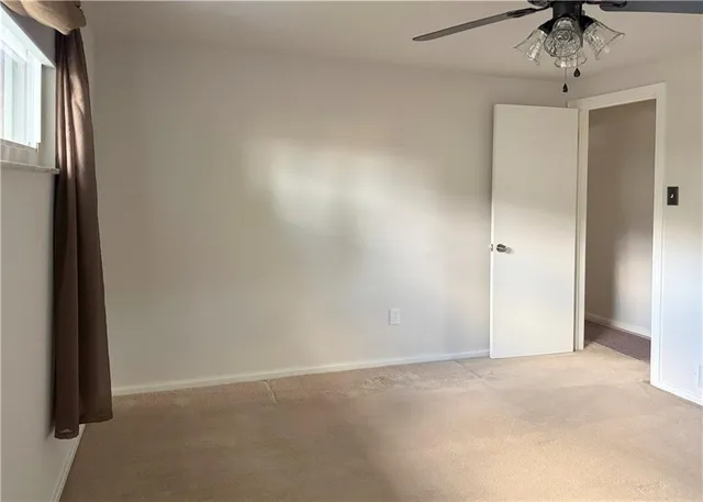 an empty room with a empty space and windows