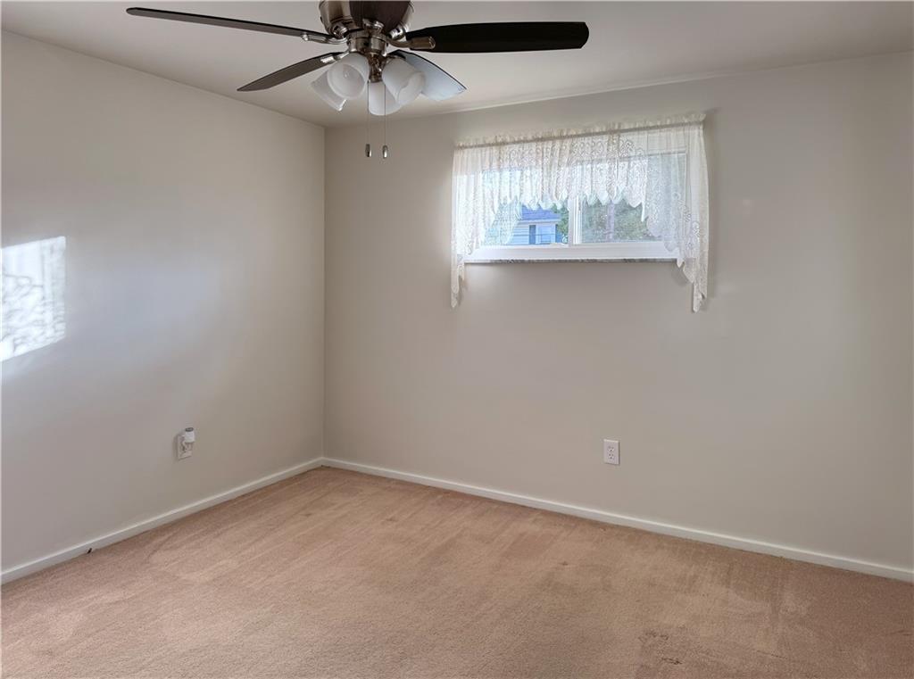 1533 Indiana Avenue Monaca, PA 15061 - Photo 17 of 27 an empty room with a window and a fan