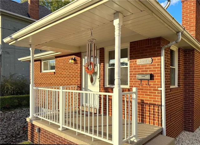 a view of a house with a small deck