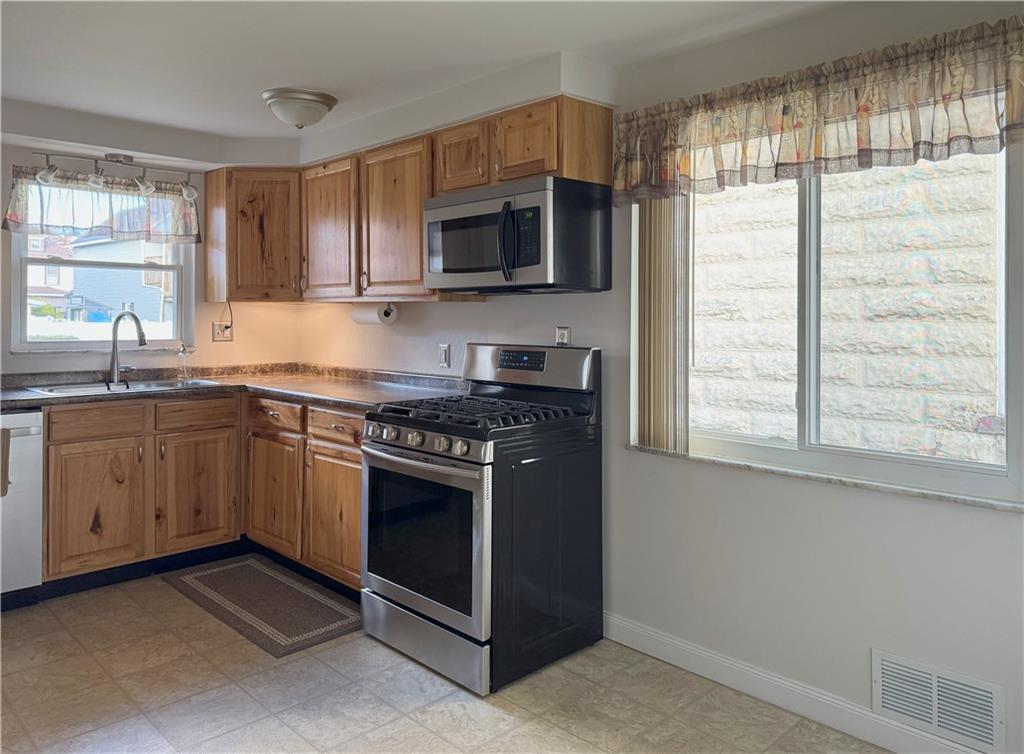 1533 Indiana Avenue Monaca, PA 15061 - Photo 6 of 27 a kitchen with stainless steel appliances a stove sink and microwave