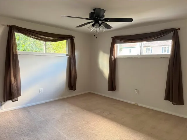 an empty room with windows and closet