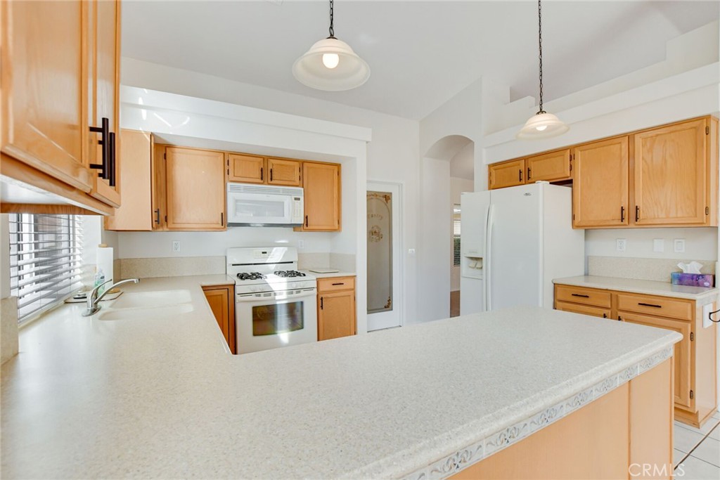 2787 Banyan Tree Lane Hemet, CA 92545 - Photo 15 of 36 a kitchen with stainless steel appliances granite countertop a sink stove and refrigerator