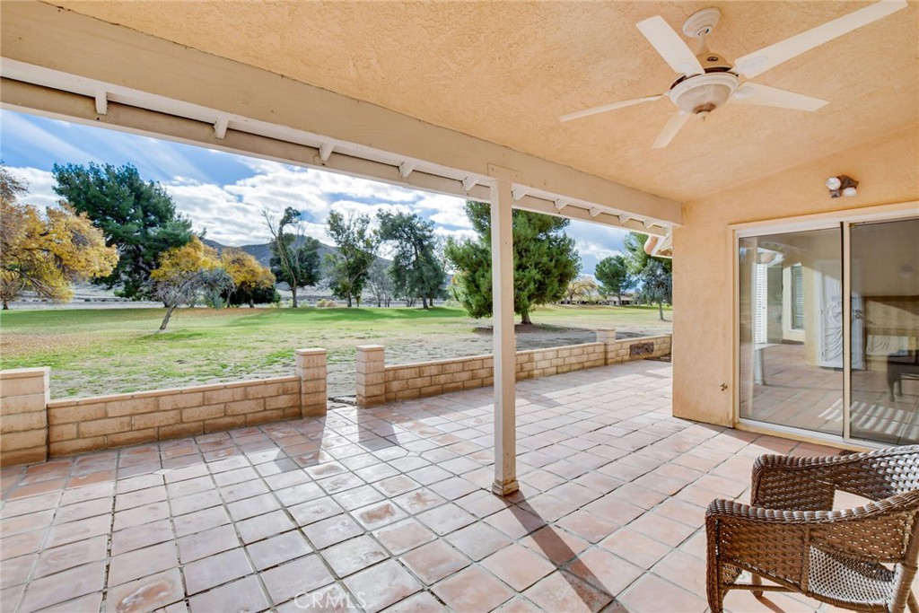 2787 Banyan Tree Lane Hemet, CA 92545 - Photo 31 of 36 a view of a patio with table and chairs floor to ceiling window with wooden floor