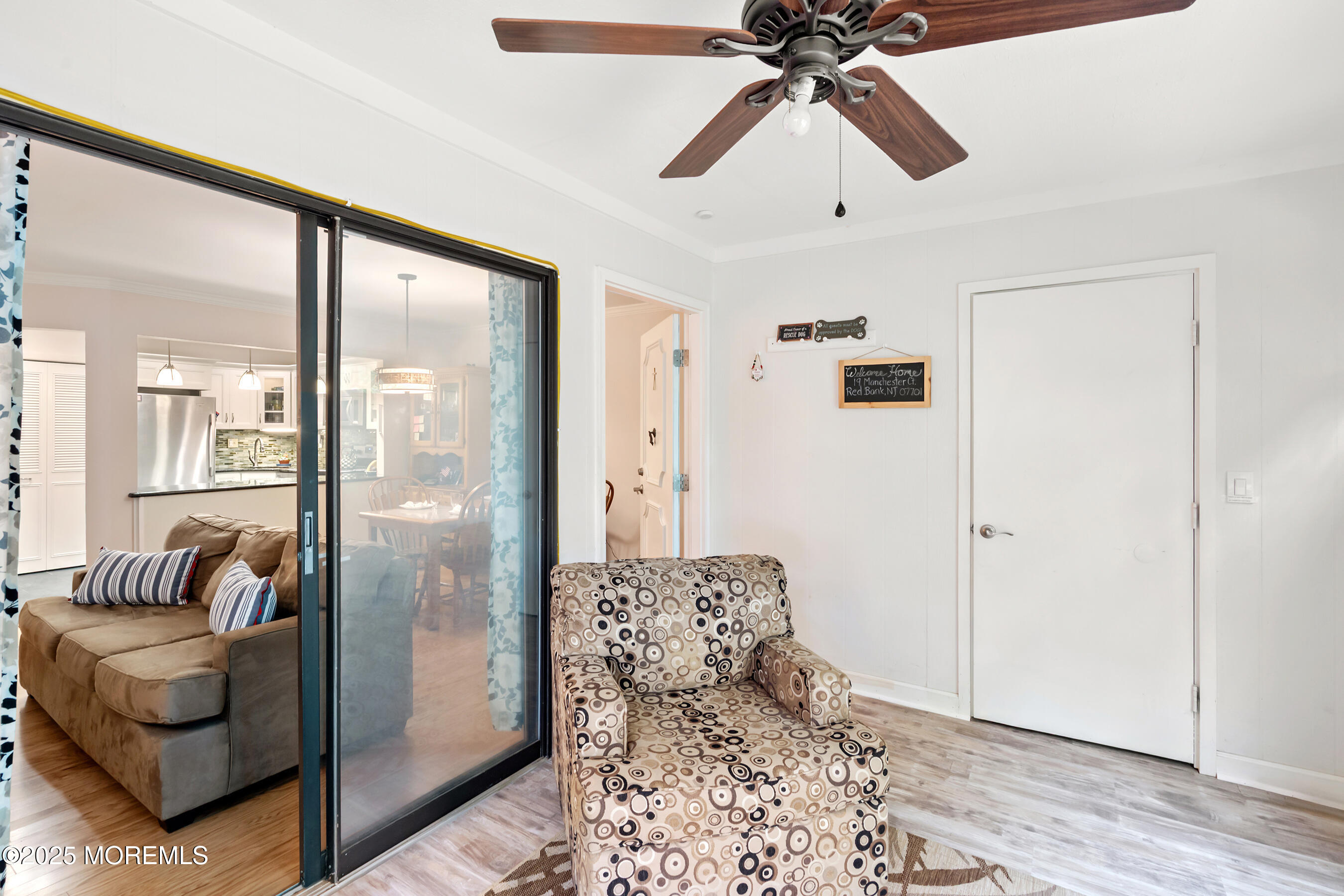 19 Manchester Court Red Bank, NJ 07701 - Photo 4 of 19 a living room with a couch and a chandelier