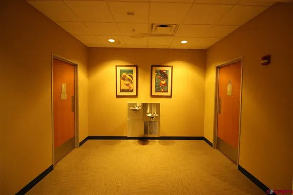 a view of a refrigerator in kitchen and utility room with wooden floor