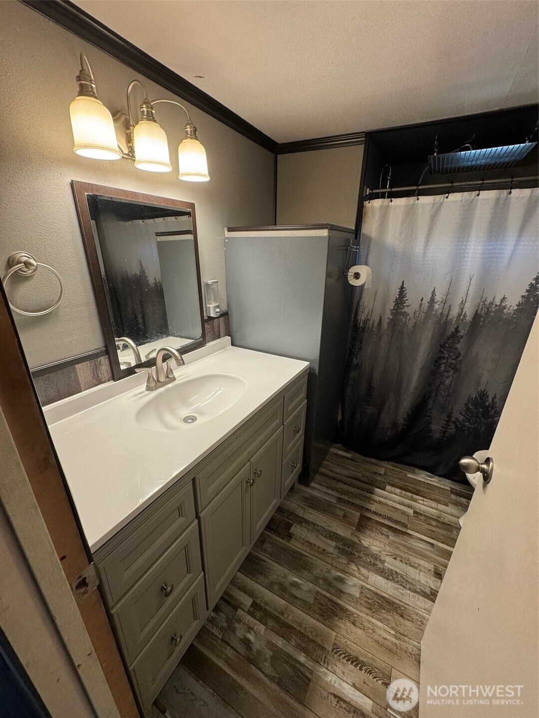 8080 Harborview Road, Unit 199 Blaine, WA 98230 - Photo 5 of 5 a bathroom with a sink a mirror and a toilet