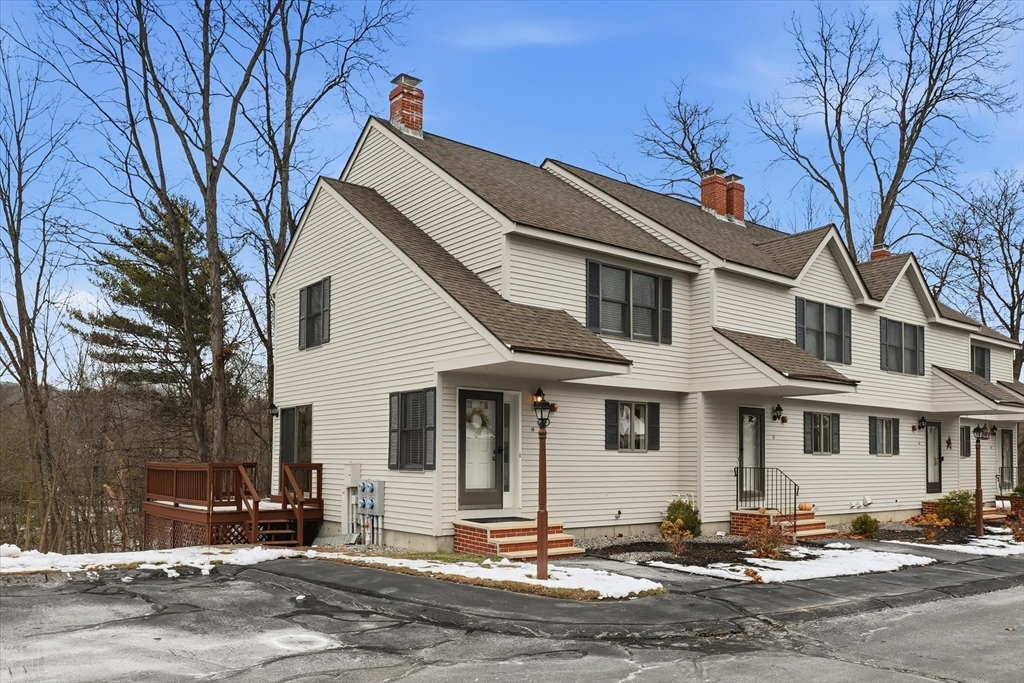 18 Carriage Court, Unit 18 Merrimac, MA 01860 - Photo 1 of 38 a front view of a house with a road