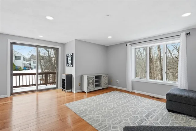 a living room with furniture and large windows