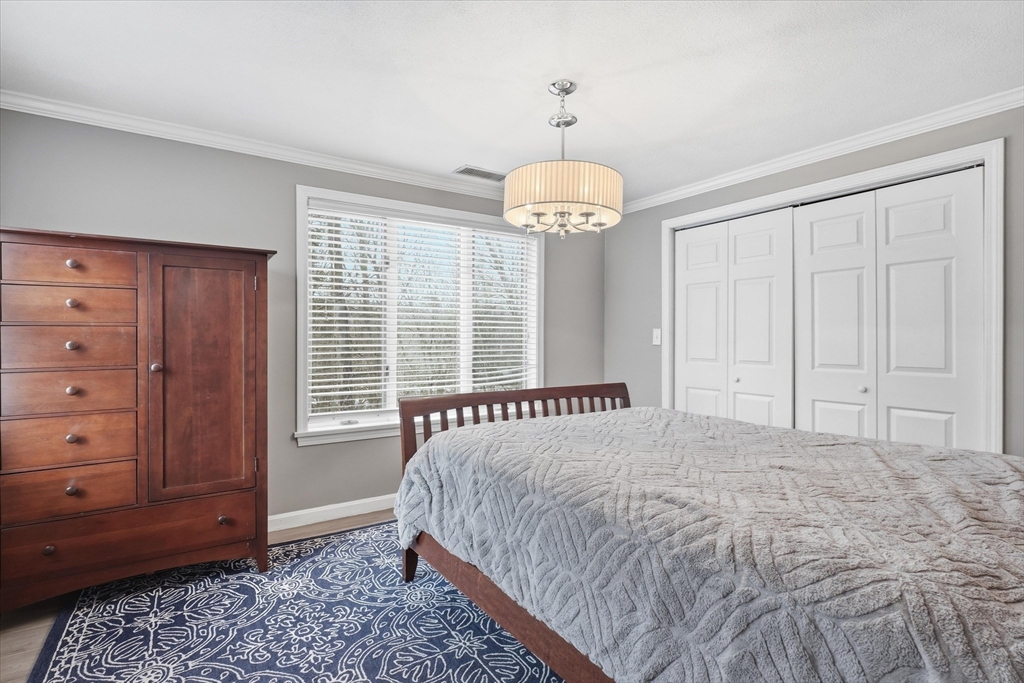 18 Carriage Court, Unit 18 Merrimac, MA 01860 - Photo 18 of 38 a bedroom with a bed and a dresser