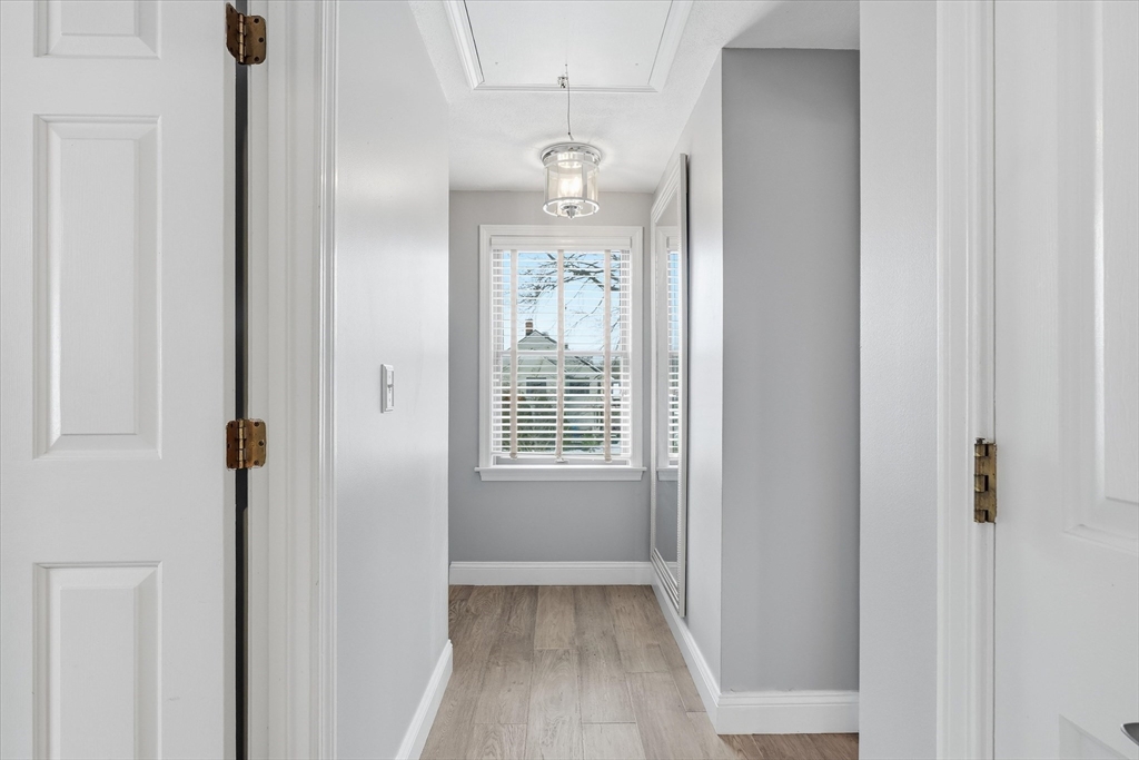 18 Carriage Court, Unit 18 Merrimac, MA 01860 - Photo 20 of 38 a view of a hallway with wooden floor and cabinet