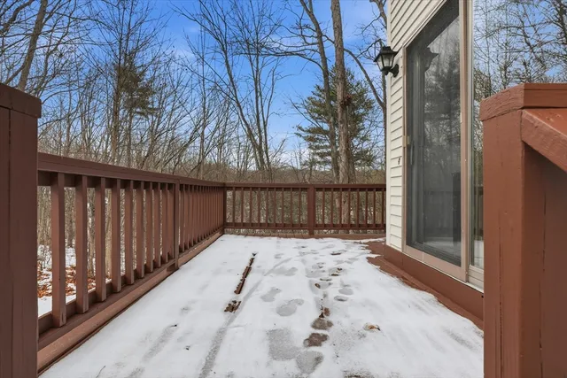 a view of backyard with wooden fence and large trees
