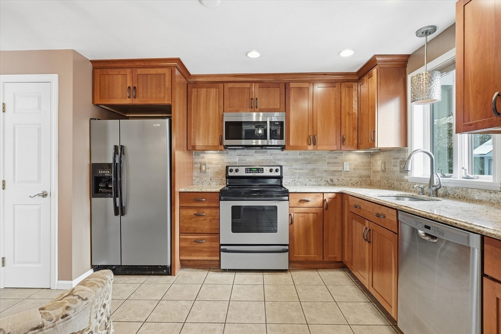 18 Carriage Court, Unit 18 Merrimac, MA 01860 - Photo 5 of 38 a kitchen with stainless steel appliances granite countertop a refrigerator and a stove