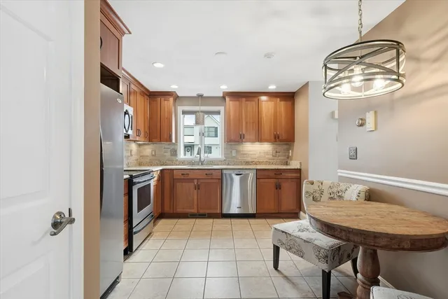 a kitchen with a sink appliances and cabinets