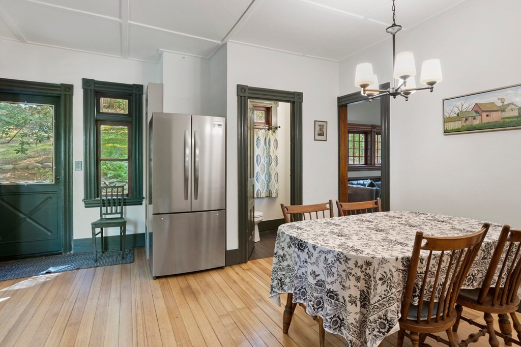 201 Winchester Road Northfield, MA 01360 - Photo 11 of 30 a dining room with furniture a chandelier and wooden floor