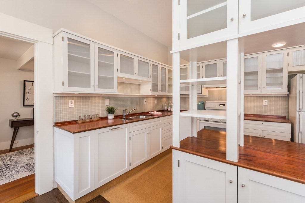 12 Willow Court, Unit A Arlington, MA 02476 - Photo 4 of 16 a kitchen with stainless steel appliances granite countertop a stove and a cabinets