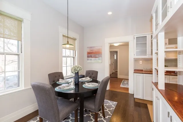 a view of a dining room with furniture and wooden floor