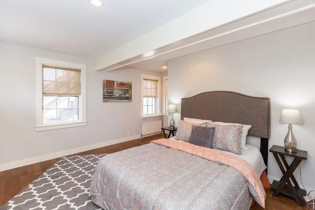 a bedroom with a bed and a lamp