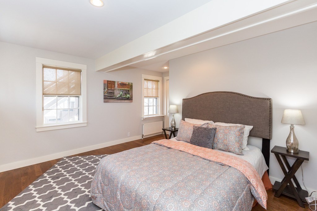 12 Willow Court, Unit A Arlington, MA 02476 - Photo 9 of 16 a bedroom with a bed and a lamp