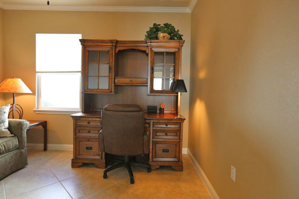 109 Ranier Lane Georgetown, TX 78633 - Photo 14 of 18 Functional office space featuring a classic wooden desk hutch and ample natural light.