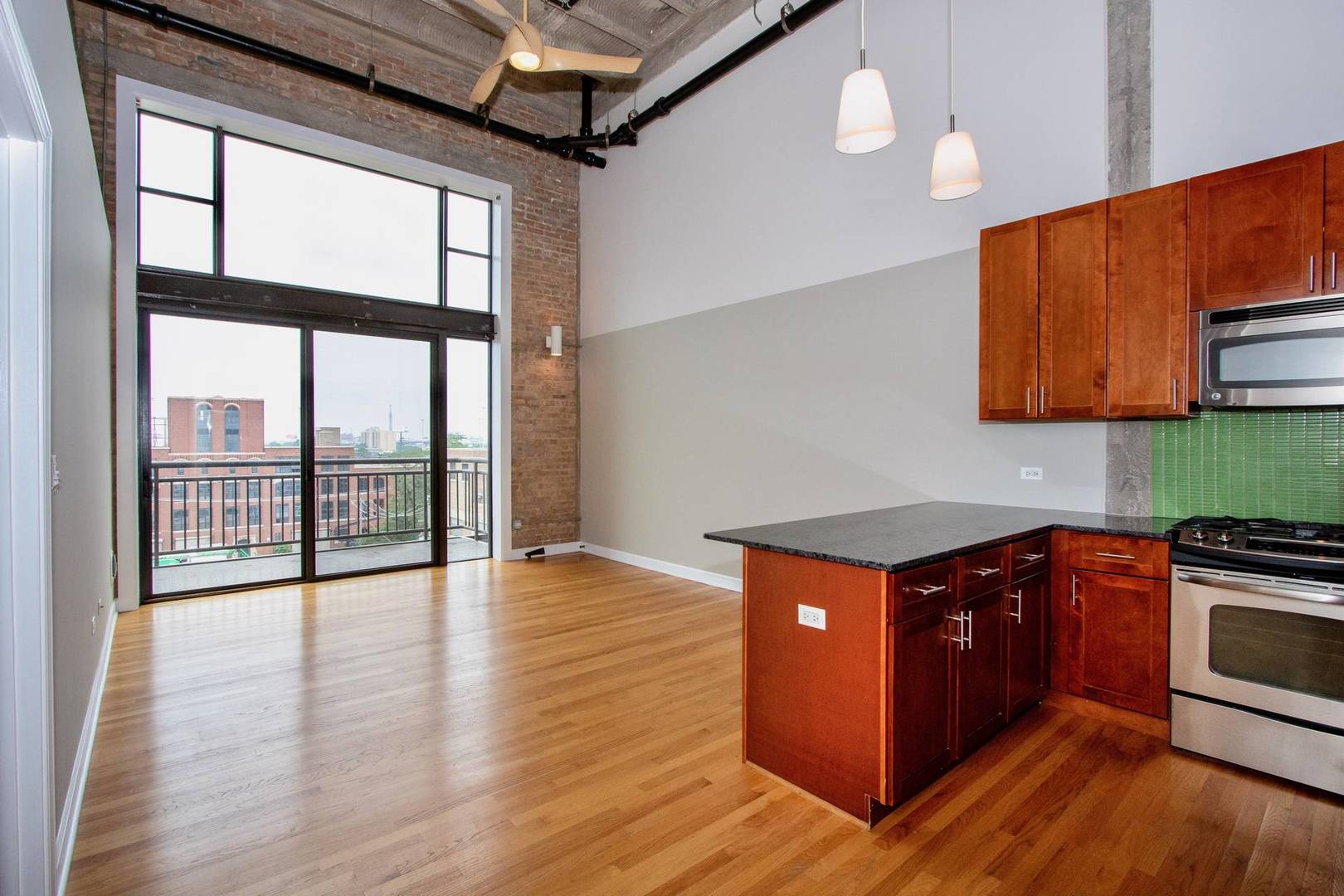 2545 South Dearborn Street, Unit 608 Chicago, IL 60616 - Photo 2 of 28 a kitchen with stainless steel appliances granite countertop a stove and a wooden floors