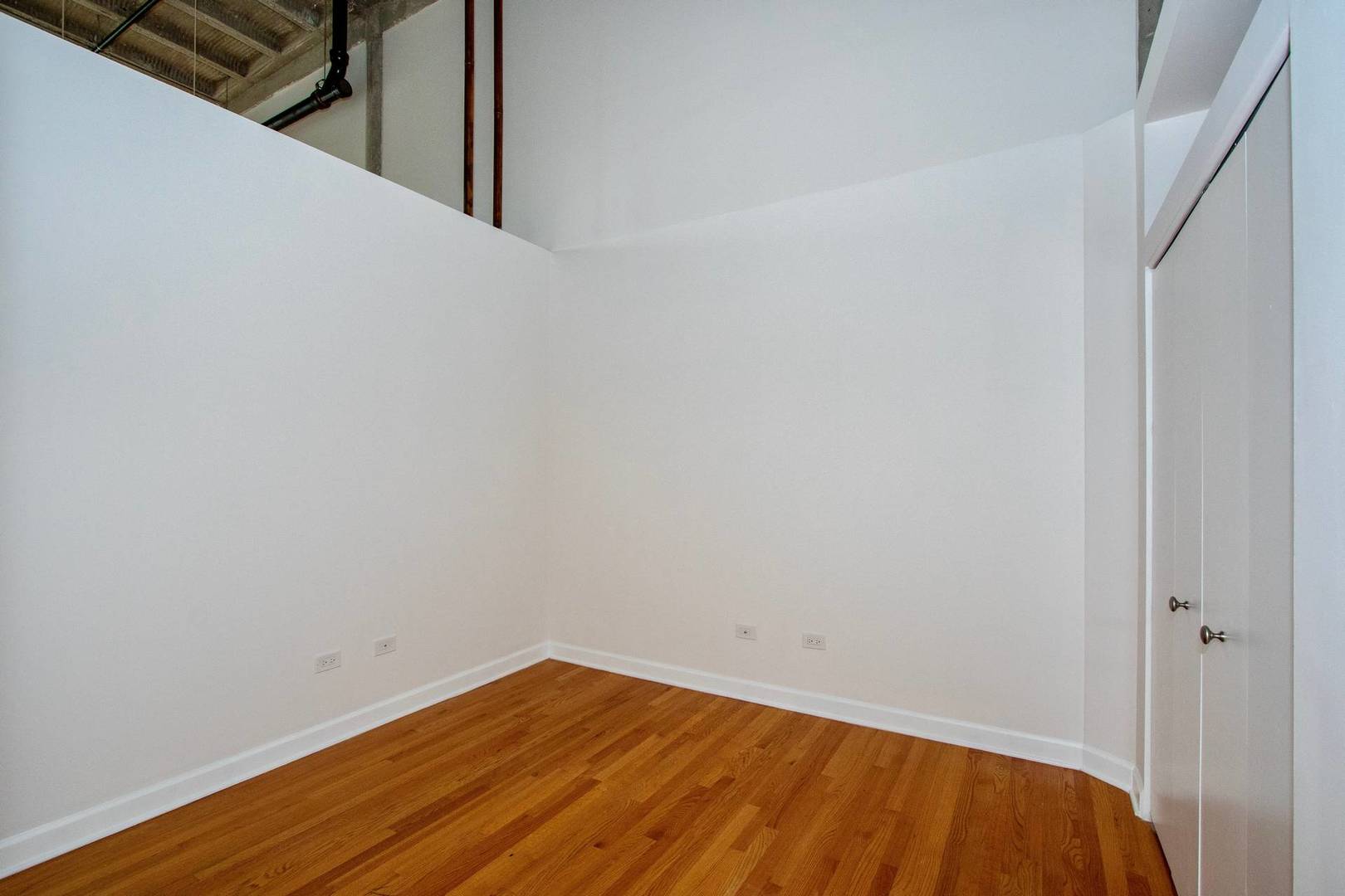 2545 South Dearborn Street, Unit 608 Chicago, IL 60616 - Photo 13 of 28 a view of a room with wooden floor