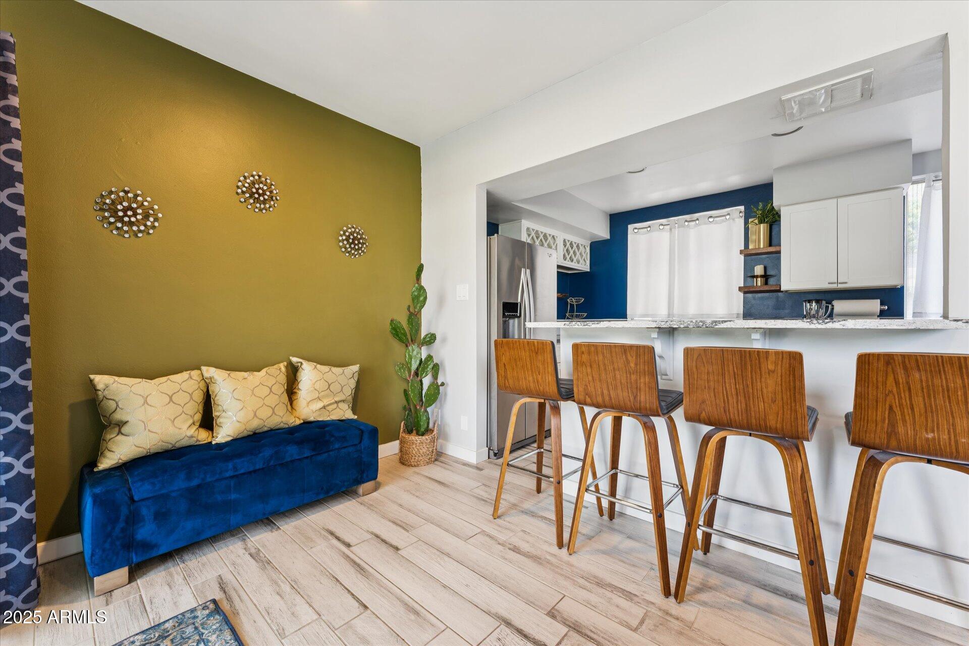 3242 East Camelback Road, Unit 105 Phoenix, AZ 85018 - Photo 12 of 24 a living room with stainless steel appliances granite countertop furniture and a wooden floor
