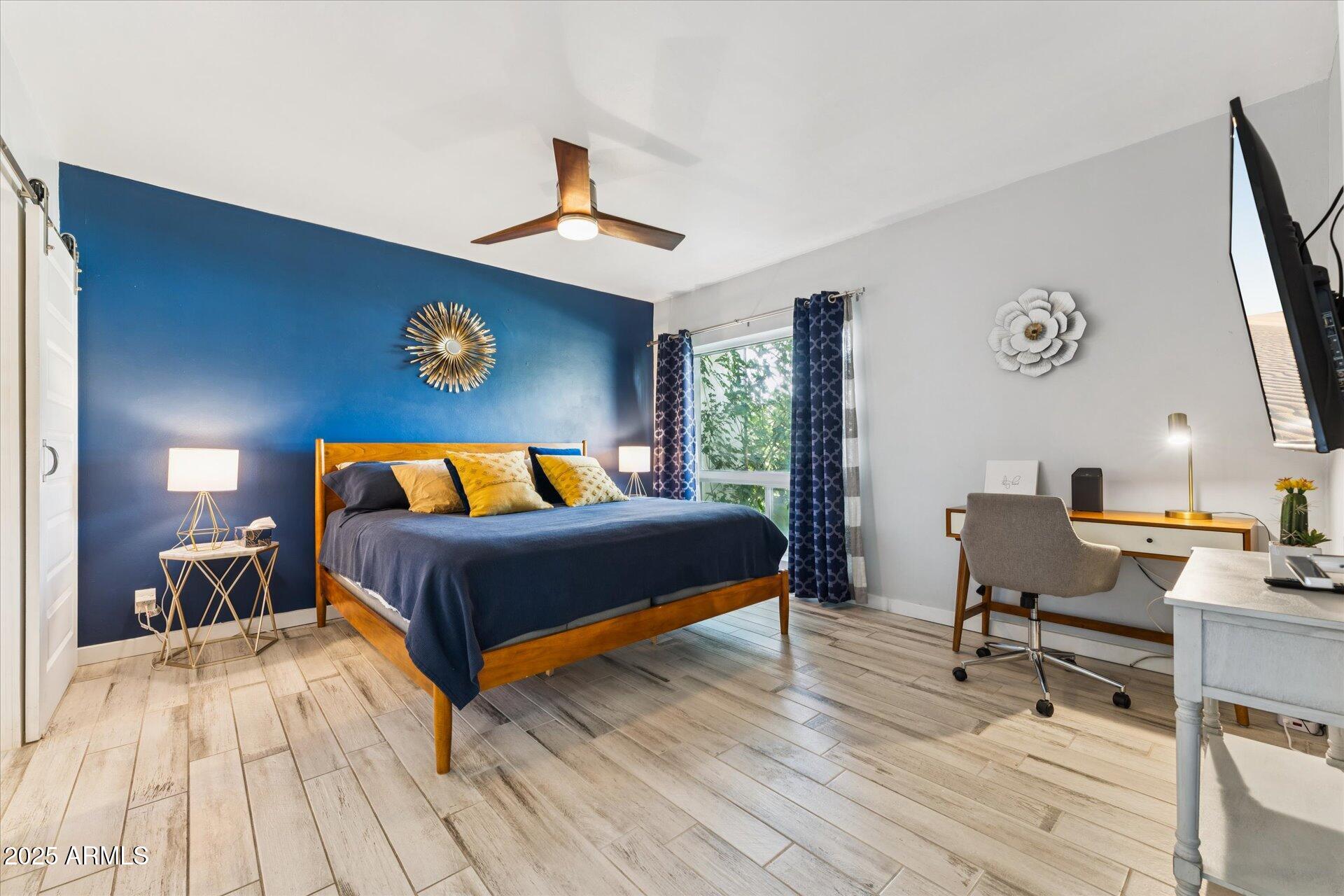 3242 East Camelback Road, Unit 105 Phoenix, AZ 85018 - Photo 13 of 24 a bedroom with a bed and a table in it